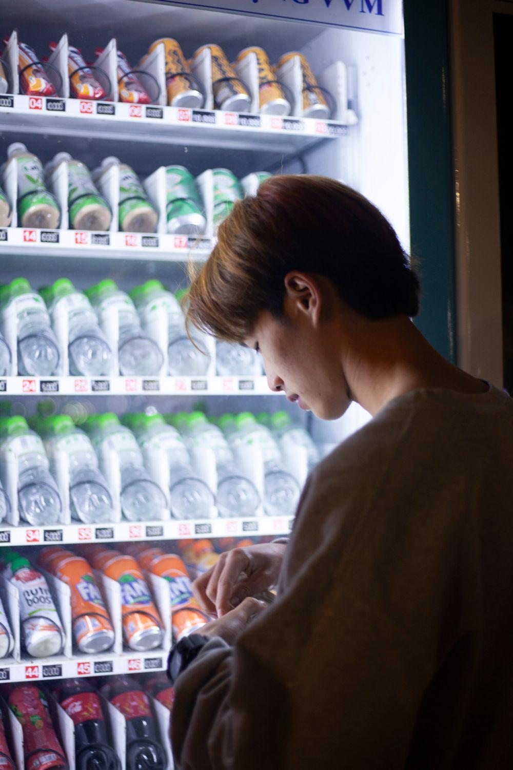 Customer picking a drink from an open smart cooler